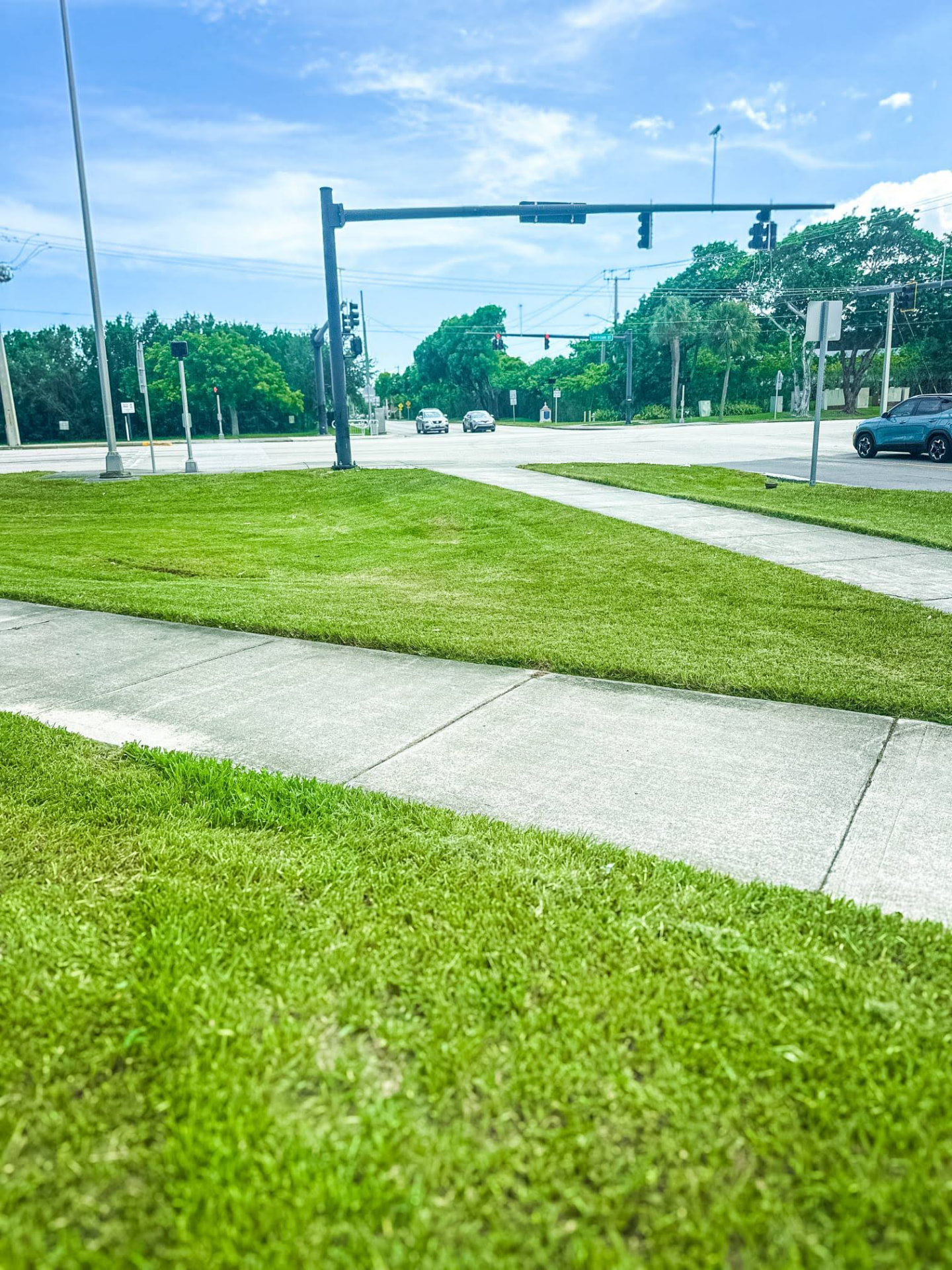 Maintained commercial corner lot with mowed lawn and clean sidewalk edging